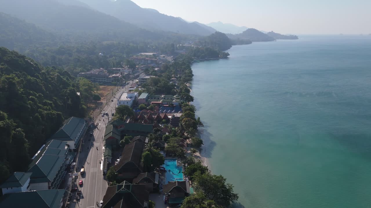 Stunning drone view of Hat Sai Khao village on Koh Chang, Thailand. Sunny morning aerial views of beaches, roads, and island landscapes