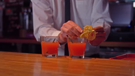 bartender pouring cocktails on counter