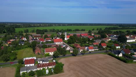 idyllic scenery of tarmow, a small village nestled amidst vast agricultural fields in brandenburg, germany, on a sunny summer day. drone shot footage from above
