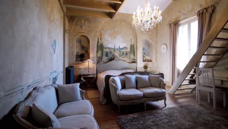 interior view of livingroom of a old and historical castle in southern france with wall painting and furniture