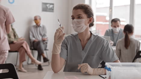 female doctor posing with syringe