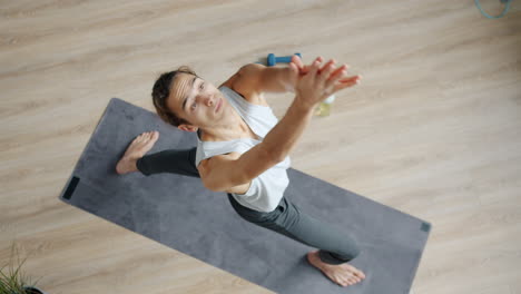 man practicing warrior yoga pose