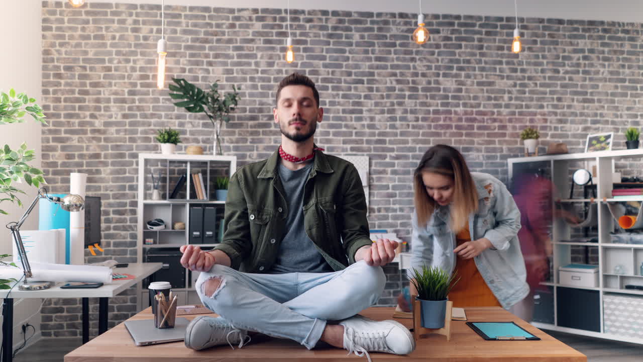 Man Meditating in Busy Office