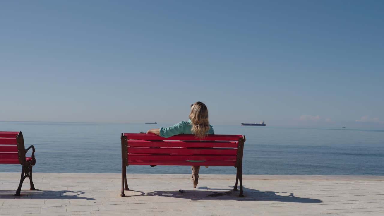 Tourist Woman Relaxing On The Bench By The Seaside In The Promenade Of Durres In Albania. Static Shot