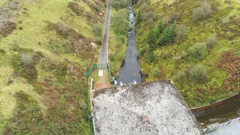 Alwen-reservoir-industrial-hydroelectric-landmark-birdseye-tilt-up-over-historical-rural-lake-dam-building