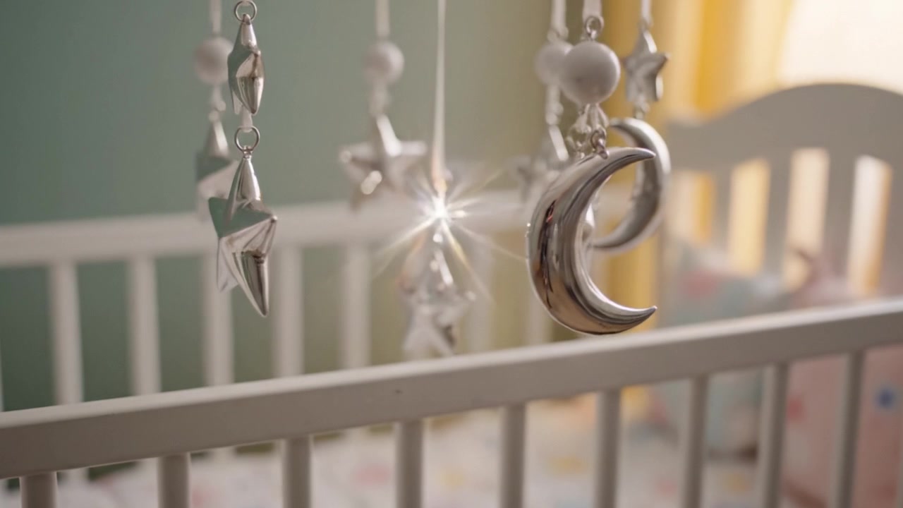 Delicate and Dreamy Mobile of Stars and Moons Above a Crib, Creating a Whimsical Atmosphere in a Tranquil Nursery Space for Babies and Toddlers