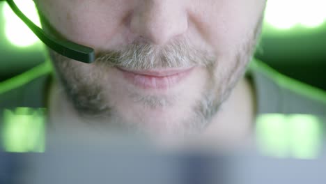 Depth-of-field-close-up-of-bearded-male-customer-service-rep-on-phone