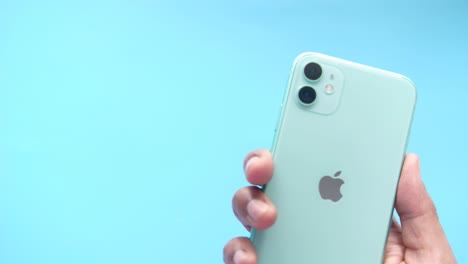 mint green iphone in hand