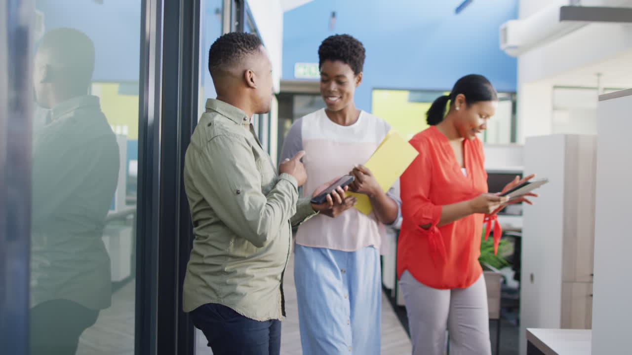 African american business people discussing work at office, slow motion