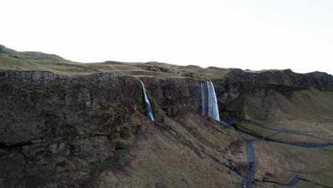 Volcanic-cliffs-with-stunning-waterfalls-in-Iceland,-aerial-on-cloudy-day