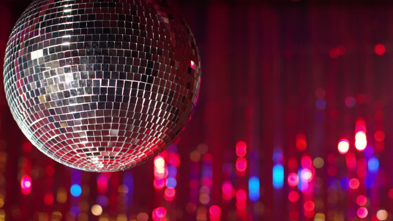 Close Up Of Mirrorball In Night Club Or Disco With Flashing Strobe Lighting And Sparkling Lights In Background 1