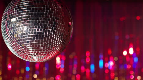 Close-Up-Of-Mirrorball-In-Night-Club-Or-Disco-With-Flashing-Strobe-Lighting-And-Sparkling-Lights-In-Background-1