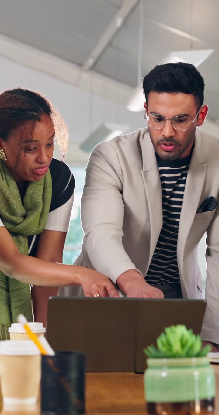 Two Business Professionals Collaborating on a Project Using a Laptop