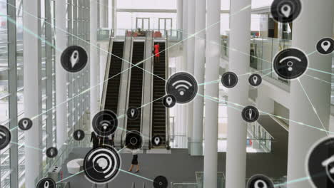 red de iconos digitales contra la vista desde arriba de la oficina moderna