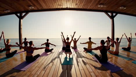 group yoga session by the ocean at sunrise