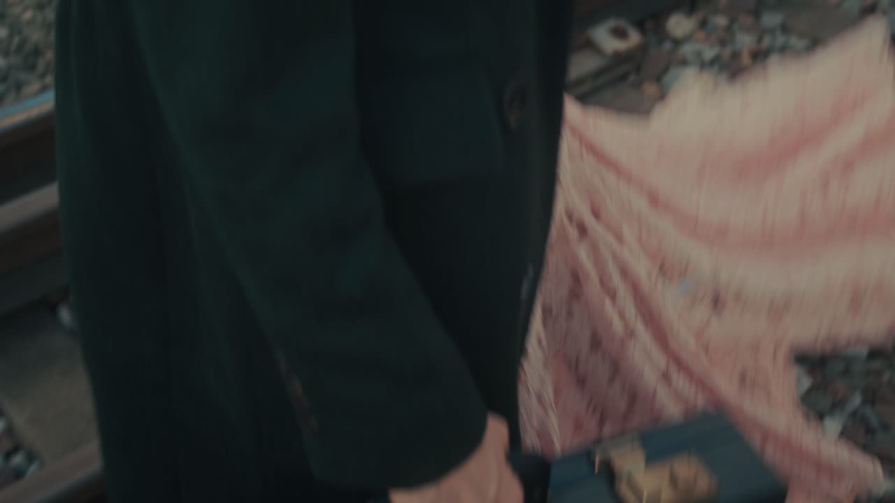 Woman walking on train tracks