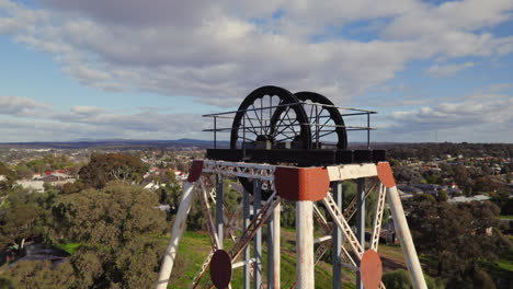 close-up circling drone shot of victoria hill mining reserve poppet head in bendigo