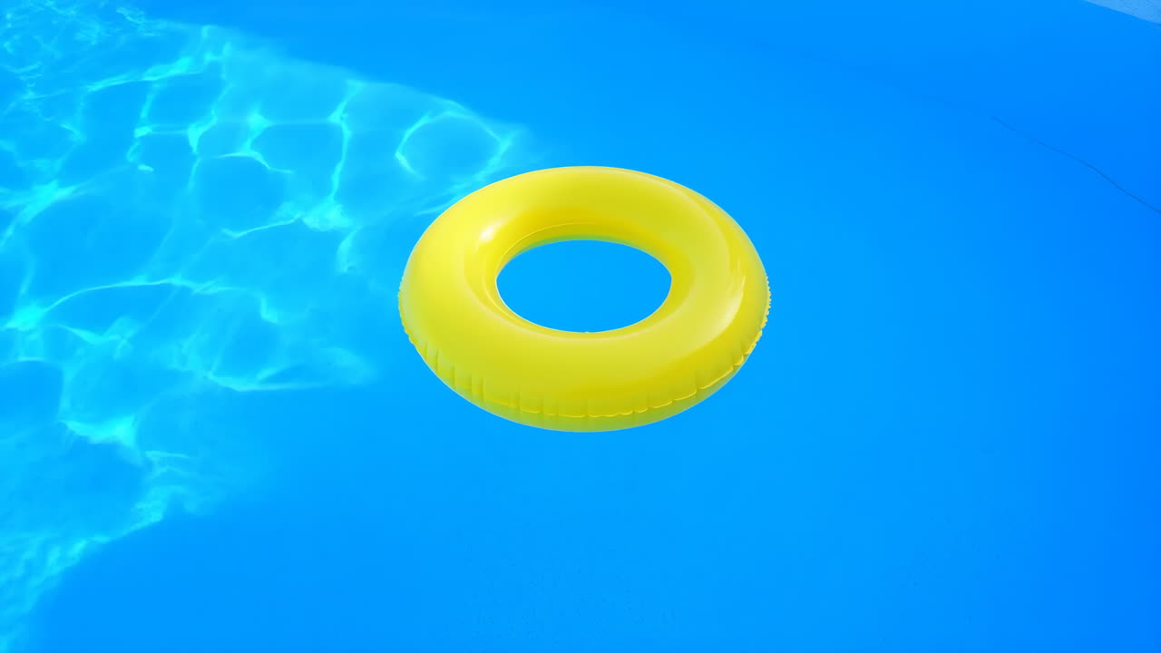 Yellow Inflatable Ring Floating in Blue Swimming Pool