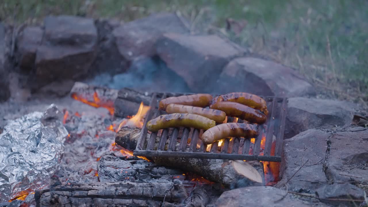 close up of bbq barbecue grilling fresh sausage meat during excursion adventure outdoor experience