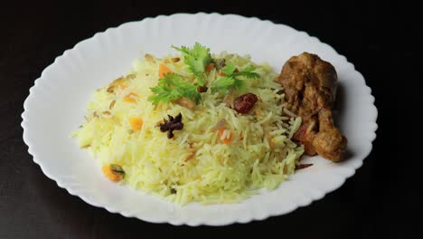 chicken biryani showing leg piece - it's a delicious recipe of basmati rice mixed with with spicy marinated chicken in a bowl. served in a bowl or plate. selective focus