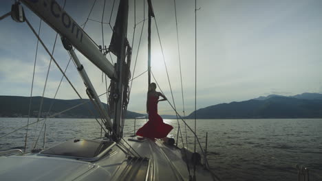 woman in red dress on a yacht at sunset