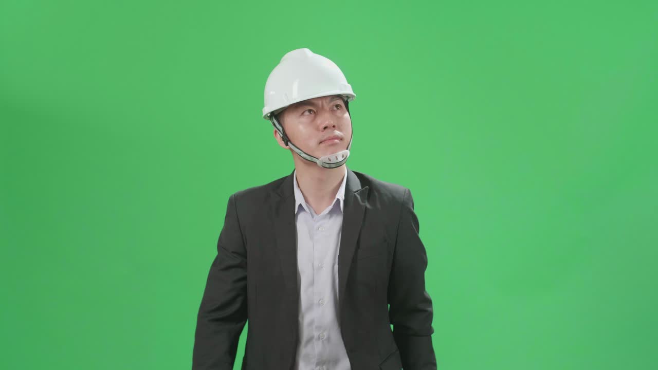 Asian Chief Engineer In The Hard Hat Walks On Green Screen Chroma Key