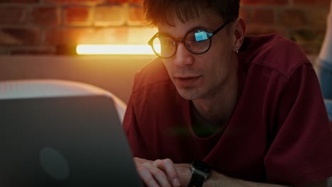 Man Working on Laptop in Bed at Night