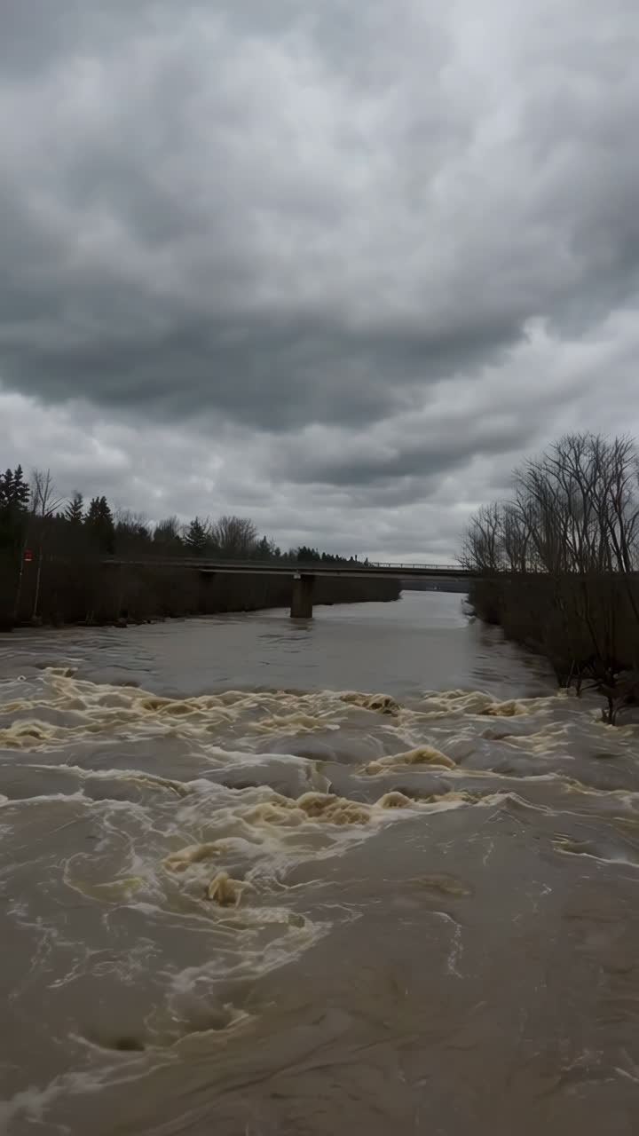 Turbulent River Flowing Under a Gloomy Overcast Sky