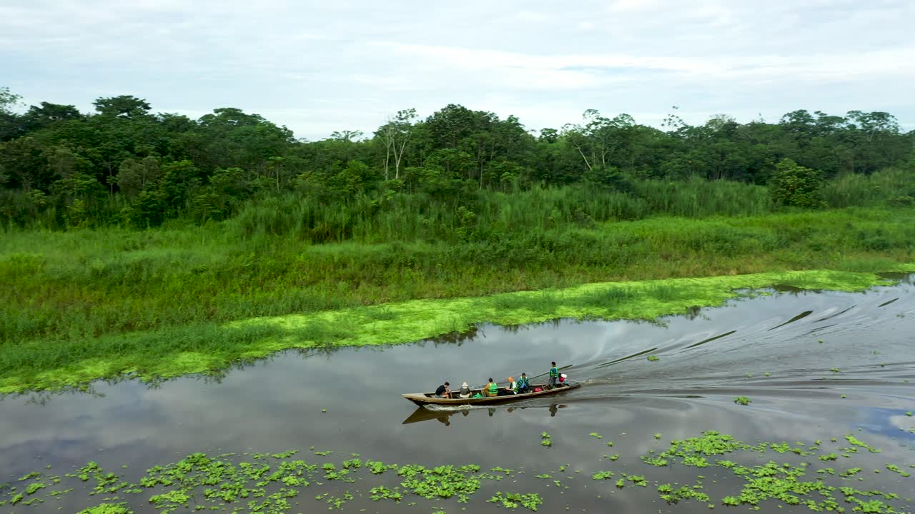 Wooden Boat with Peruvian People Traveling on Amazon River - Aerial