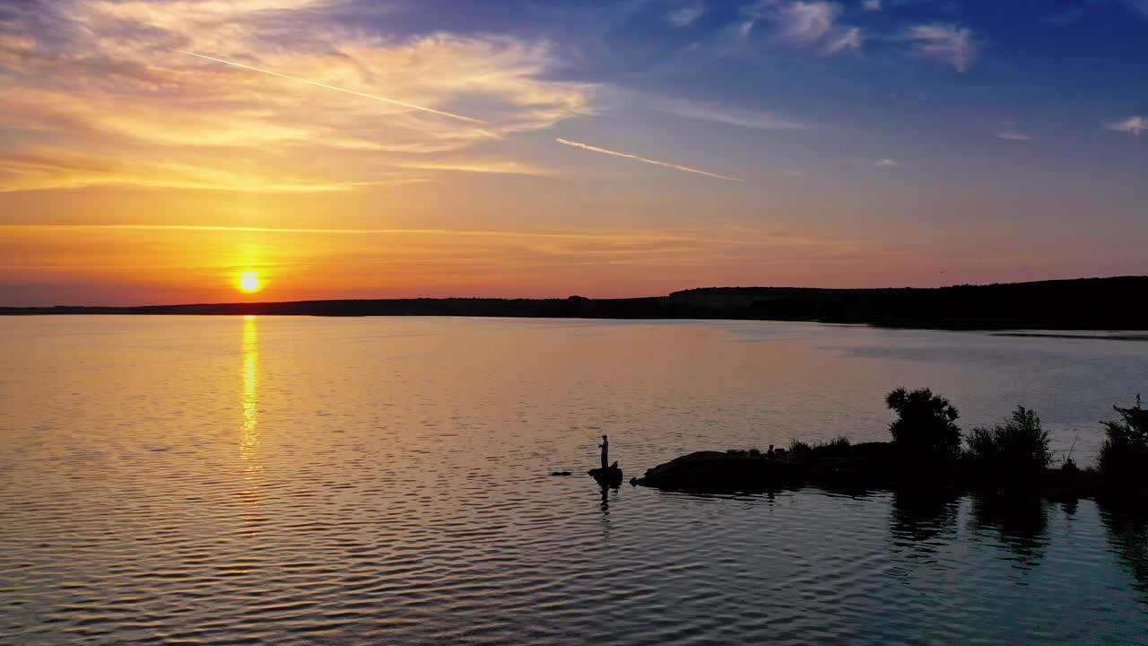 Beautiful sunset is reflecting in the river. Sunset lake landscape. Colorful sky.