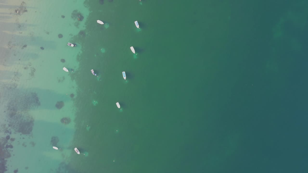 Yacht And Boats Floating In The Calm Blue Waters Of Lake Garda In Italy