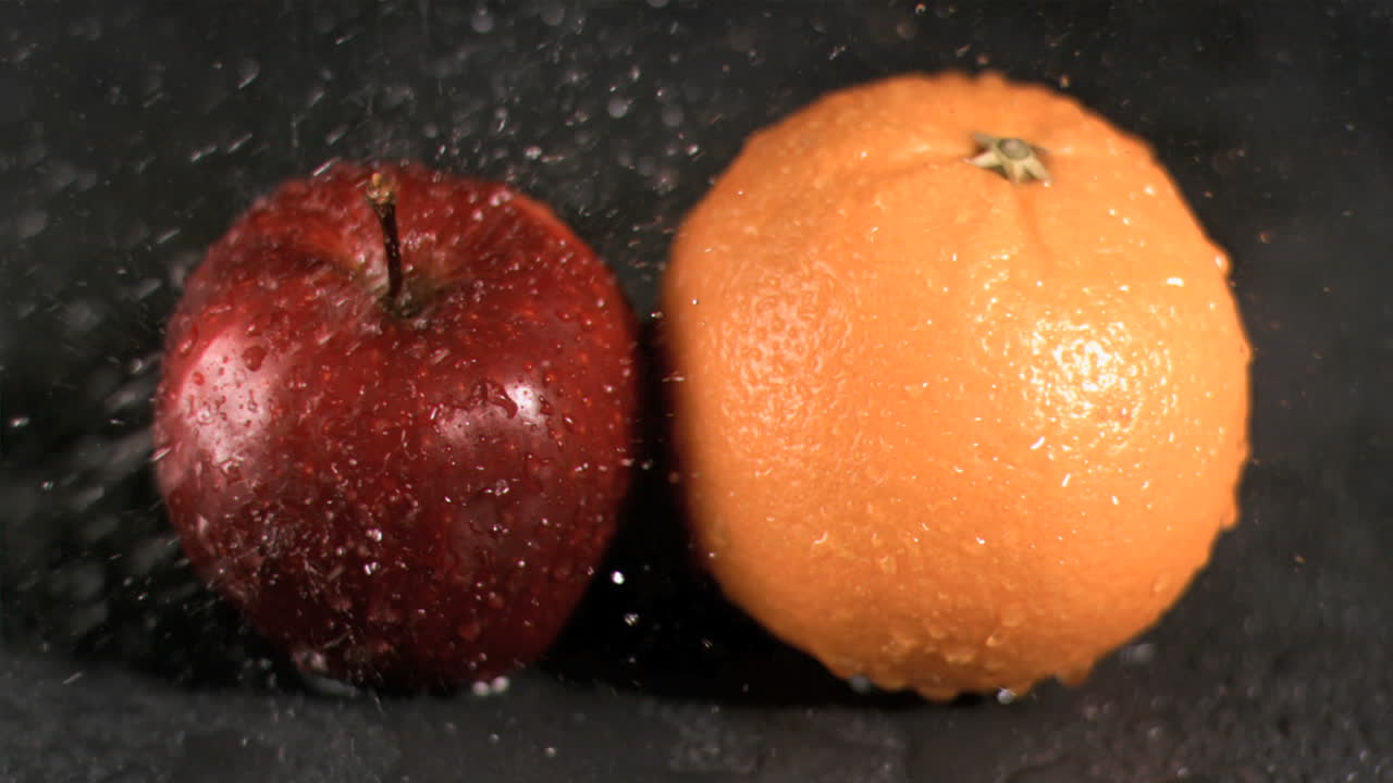 Water sprayed on fruits in super slow motion