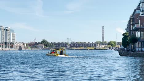 viking splash tour at the grand canal dock in dublin with the poolbeg towers in the background.