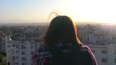 woman looking at the sunrise ower the hurghada city. egypt