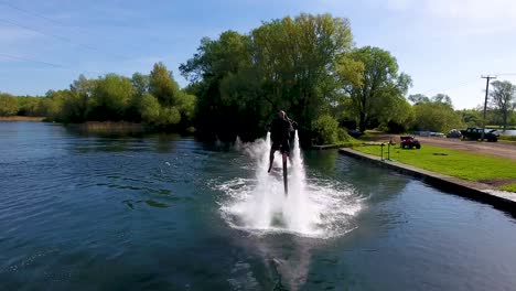 jetlev flyer, athlete, sportsman flying and chasing camera before turning off