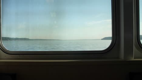 ferry interior with empty rows of seats on a sunny day