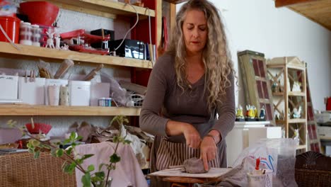 female potter working in pottery shop 4k