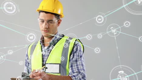 Animation-of-connected-icons,-caucasian-engineer-wearing-helmet-and-spectacles-writing-in-notepad