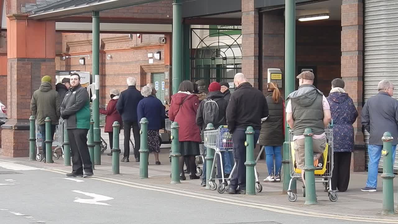 COVID Corona virus British social distancing queue at supermarket Morrisons store part I