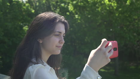 Pretty-Italian-Woman-Tourist-Taking-Photograph-of-a-Park-in-Wimbledon-London