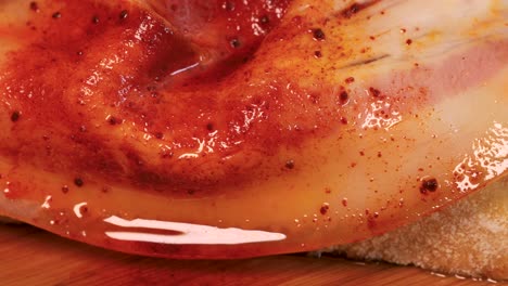 detail shot of seasoned slice of ham on top of slice of bread, macro shot in 4k