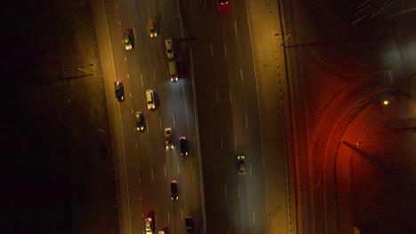 Aerial-view-of-Top-Down-Shot-of-Cars-Driving-Down-Interstate-at-Night-in-Denver,-Colorado