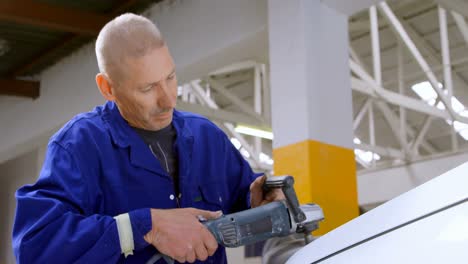 mechanic polishing a car with grinder 4k