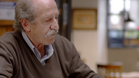 senior man having dinner in restaurant