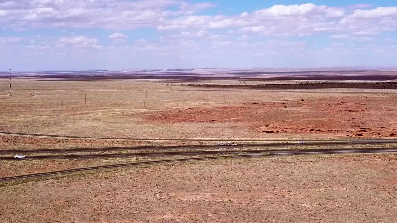 Drone over the Arizona desert near Winslow with the i40 in the background.