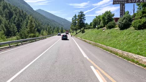 cars driving through scenic mountain roads