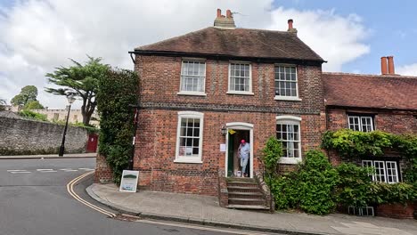 person walking by charming brick houses