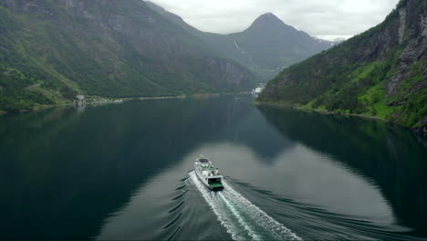 a calm fallowing shoot of a ferry in norway - geirangerfjord