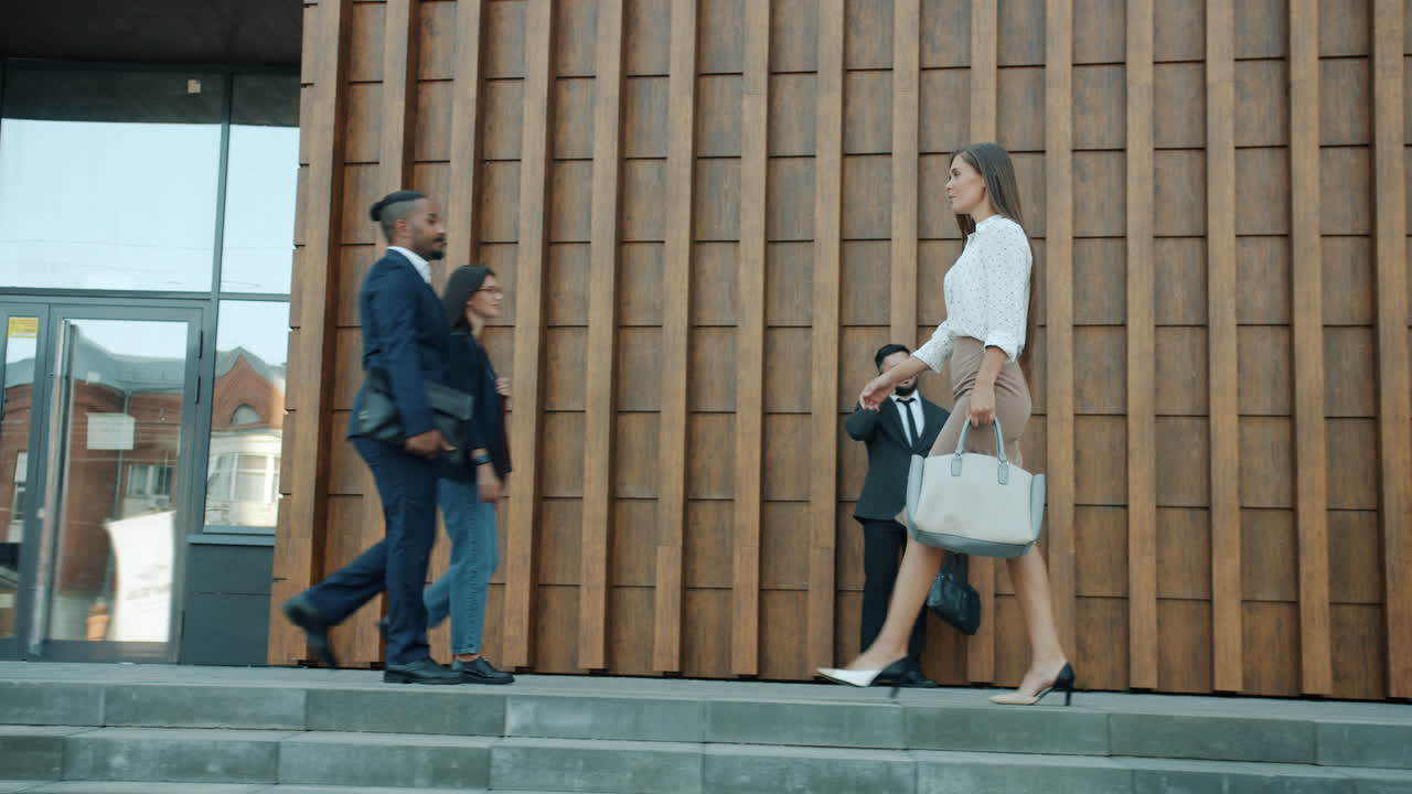 Businesswoman Walking on Stairs Outside Office Building