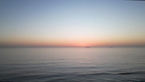 fishing-boat-in-the-sea-against-the-backdrop-of-the-setting-sun,-timelapse,-4k